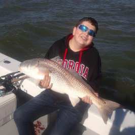 a man holding a fish in the water