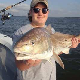 a person holding a fish in the water