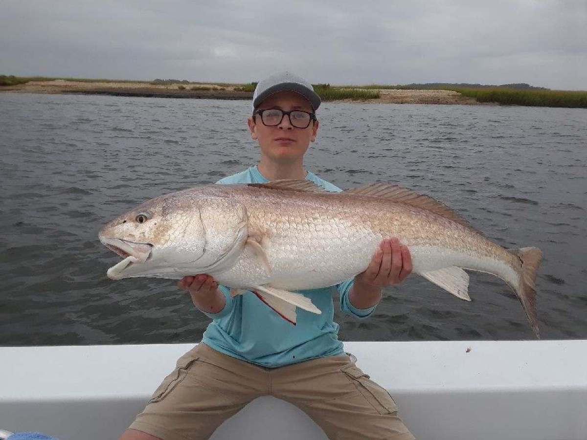 a person holding a fish in the water