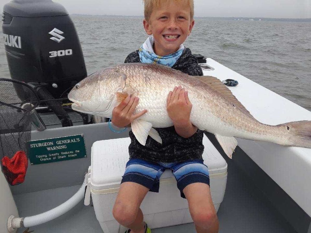 a person holding a fish