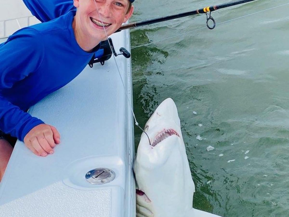 a person holding a fish in the water