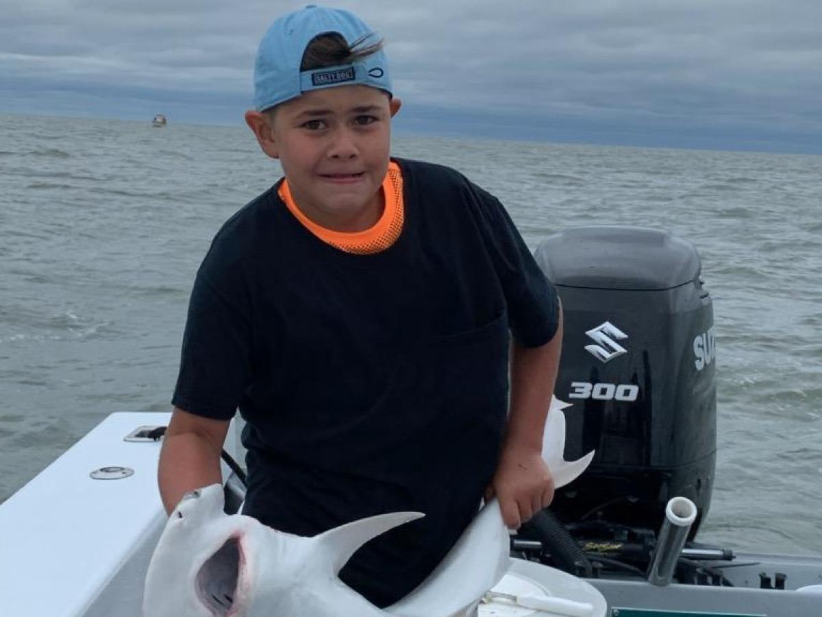 a man sitting in a boat on a body of water
