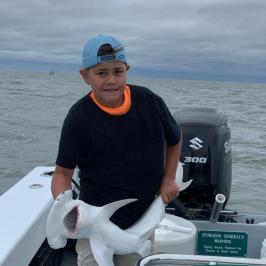 a man sitting in a boat on a body of water