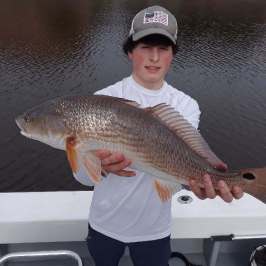 a person holding a fish in the water