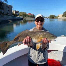 a person holding a fish swimming under water