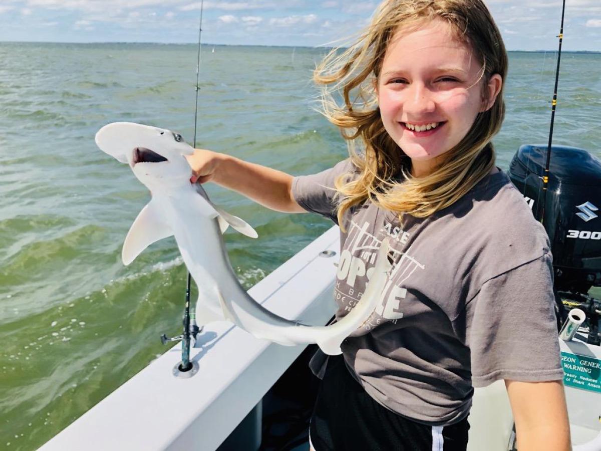a person standing next to a body of water