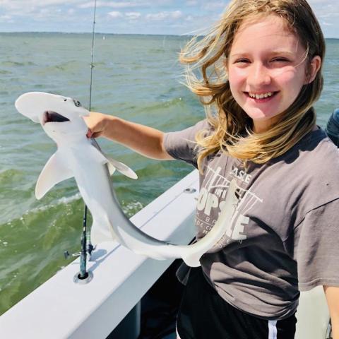 a person standing next to a body of water