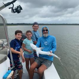 a person sitting in a boat on a body of water