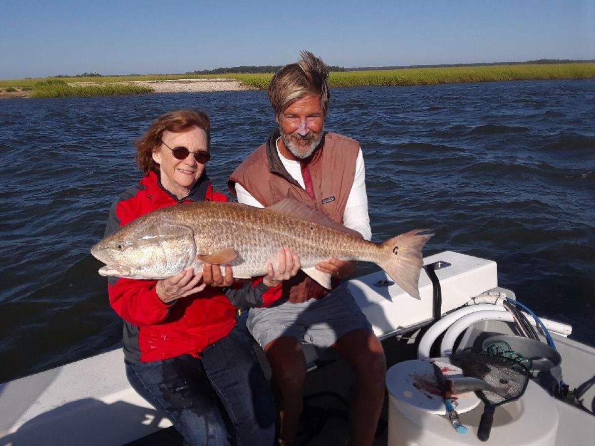 a person holding a fish in the water
