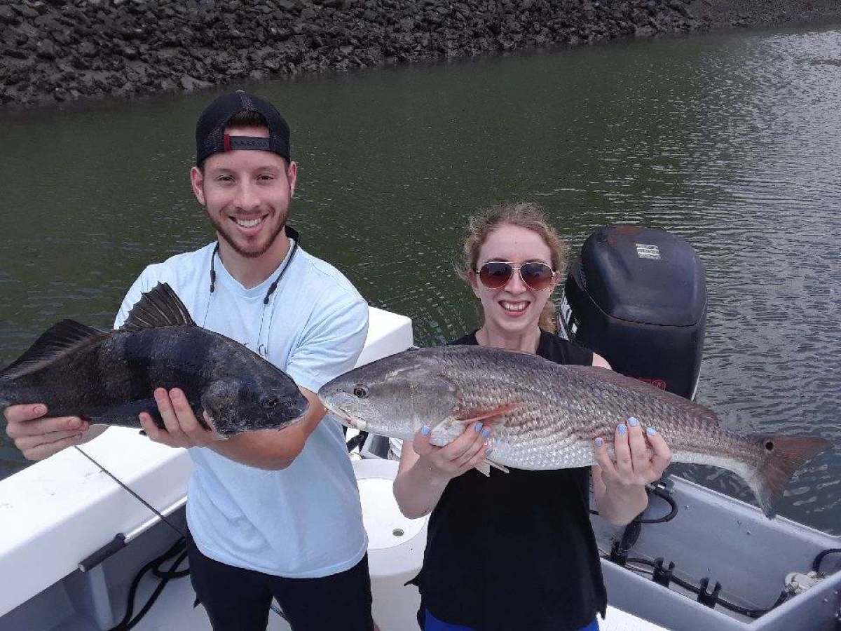 a person holding a fish in the water
