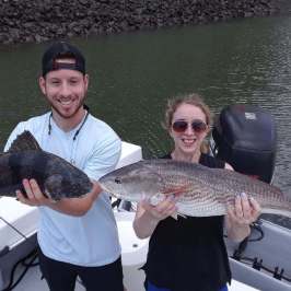 a person holding a fish in the water