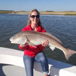 a person holding a fish in a body of water