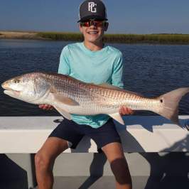 a person holding a fish in the water