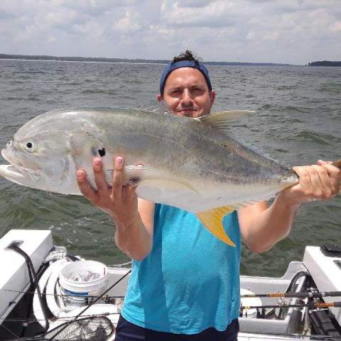 a person holding a fish in the water