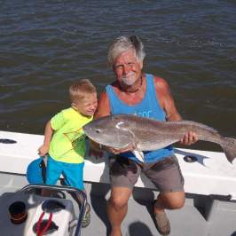 a man holding a fish swimming under water