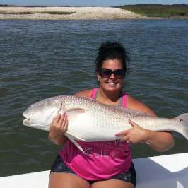 a person holding a fish in the water